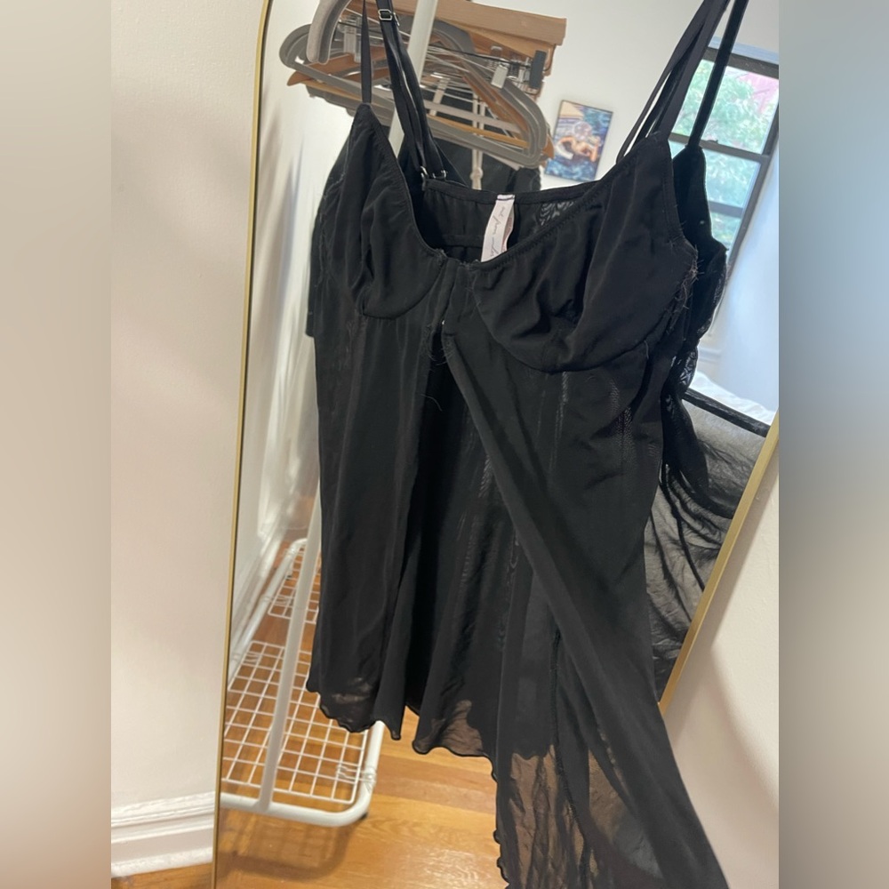 Black mesh babydoll top with adjustable straps and front closure